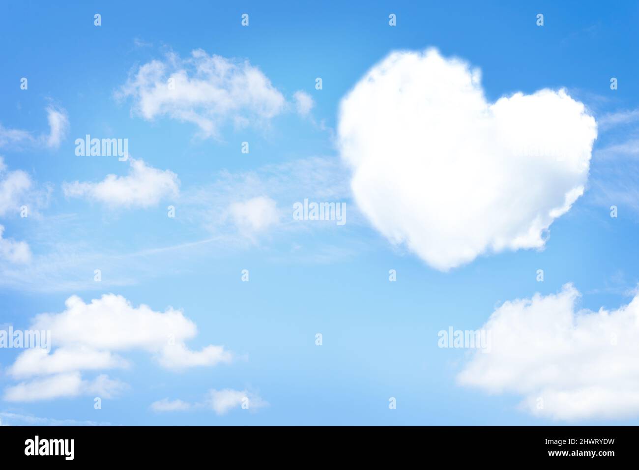 Cloud in a heart shape on bright sky background. Copy space Stock Photo ...