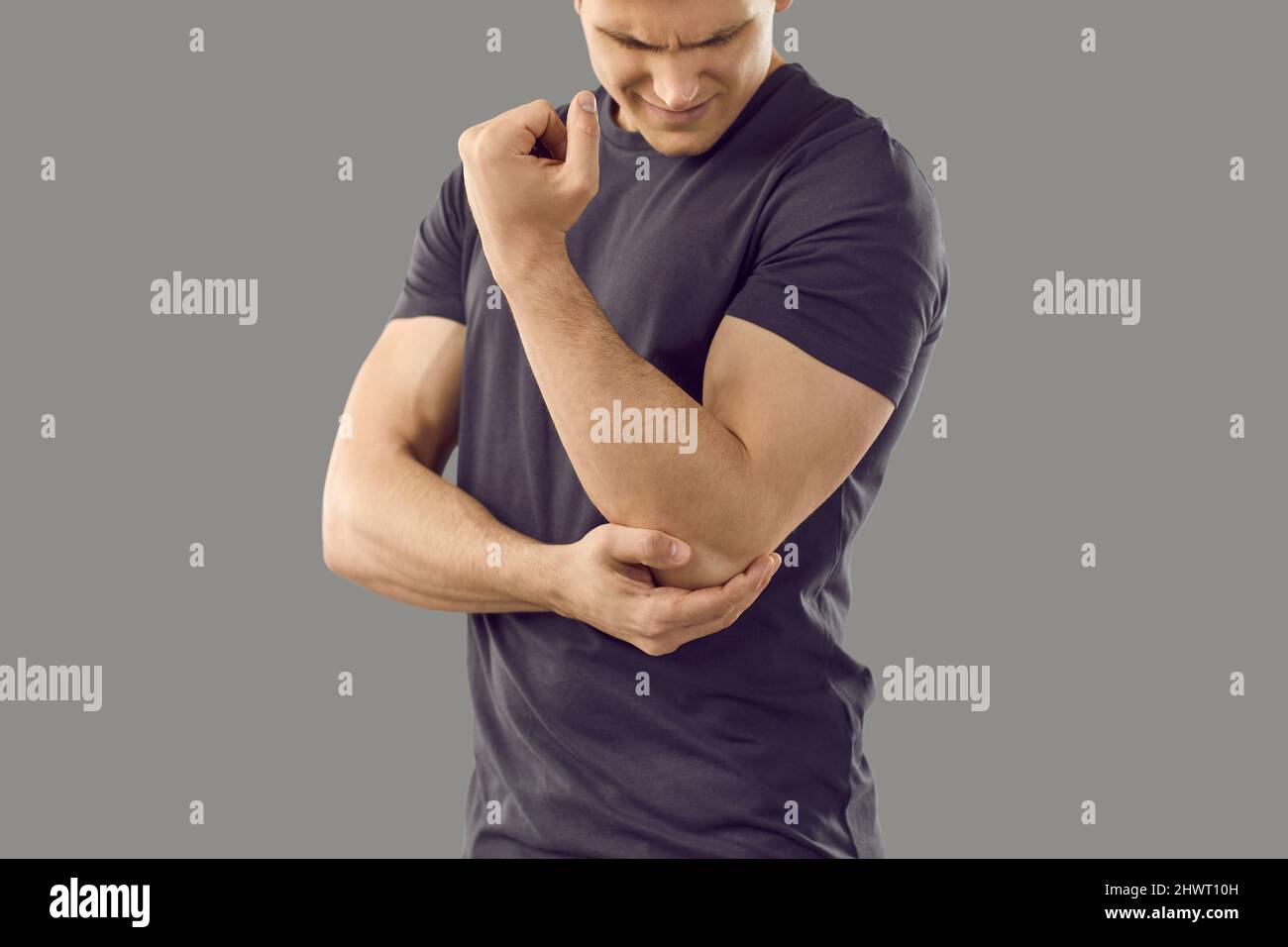 Man experiences pain in elbow joint, which may be symptom of