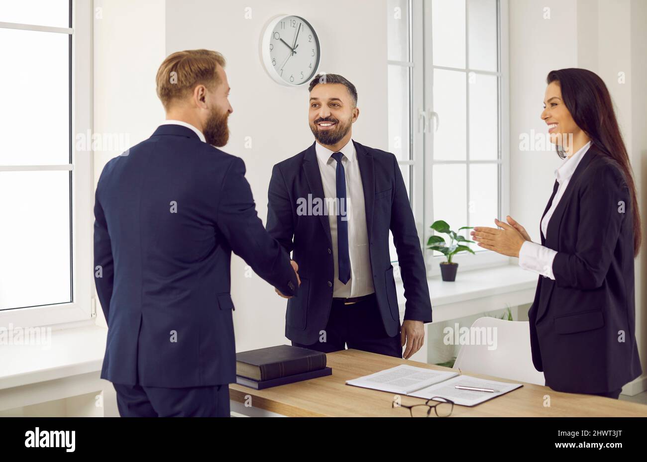 Happy client shaking hands with a business adviser or lawyer in the office or courtroom Stock Photo