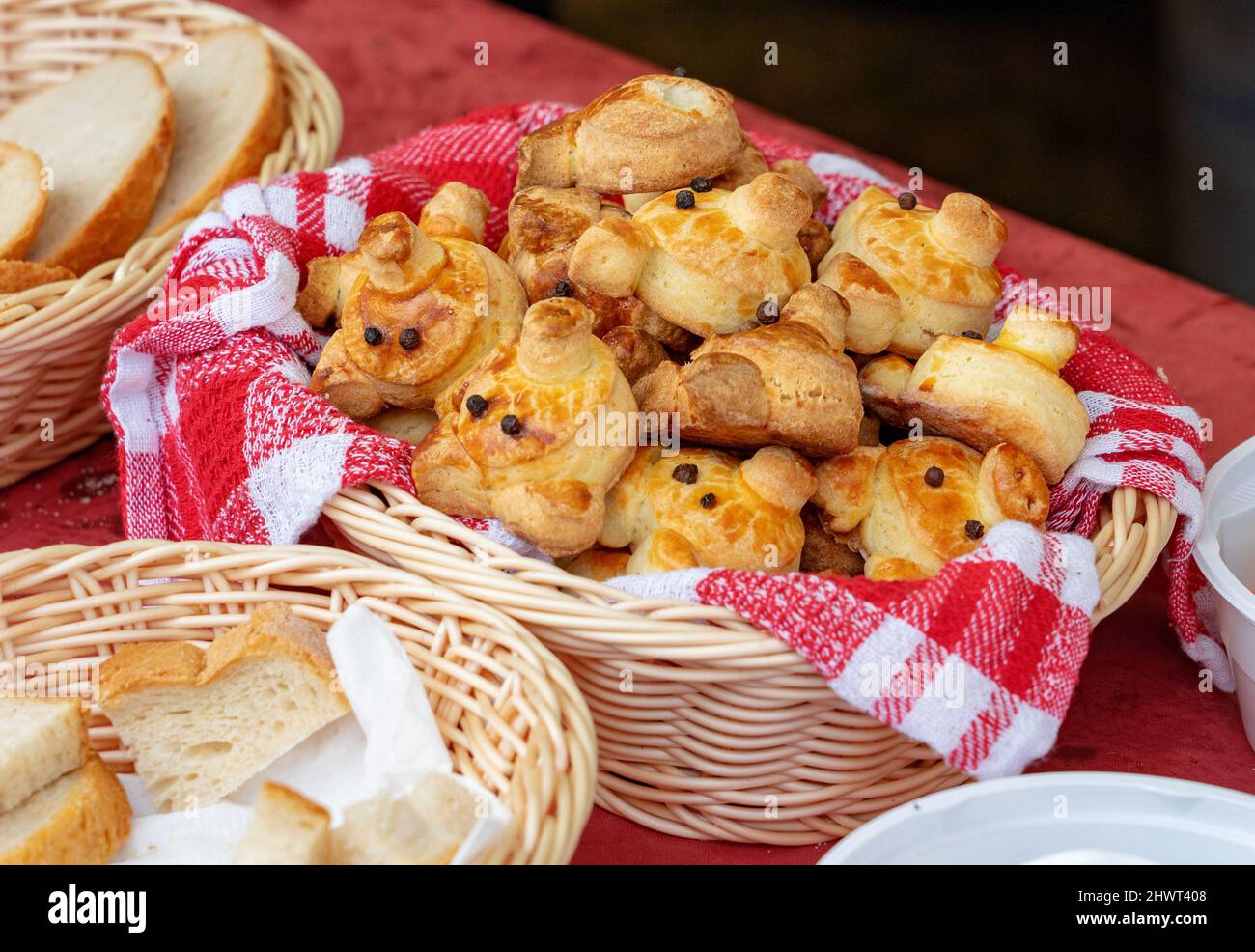 funny litte pig face traditional hungarian bakery pastry pogacsa in a basket Stock Photo