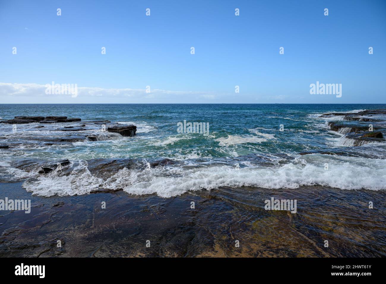 waves breaking on rocks in Australia Stock Photo