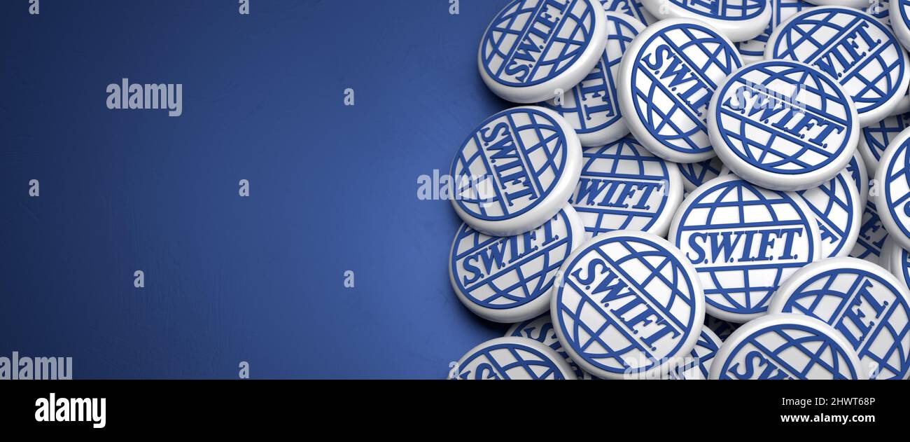 3d Logos of the executor of financial transaction between banks S.W.I.F.T. (Society for Worldwide Interbank Financial Telecommunication) on a heap on Stock Photo
