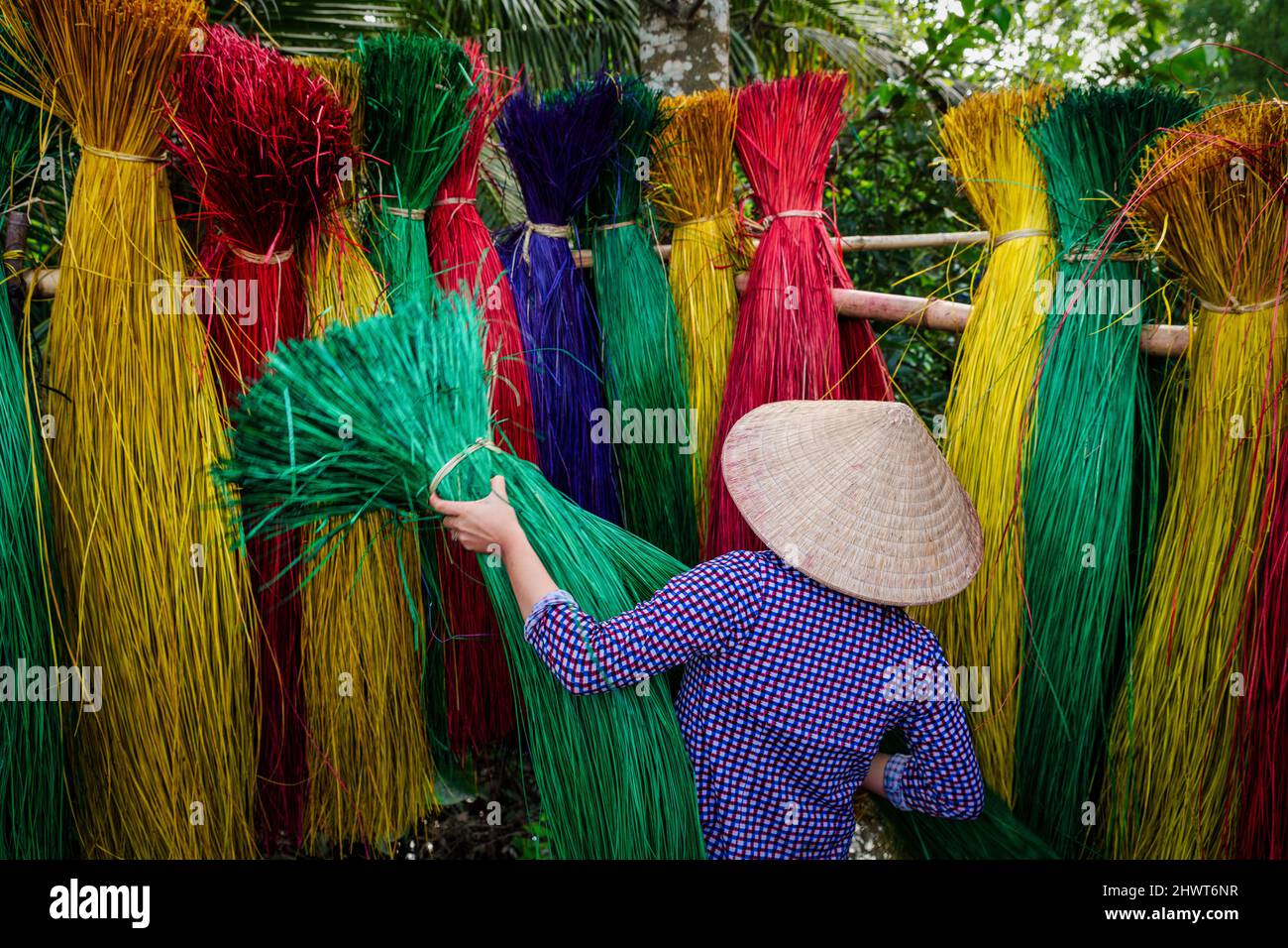 Vietnamese women drying traditional vietnam mats in the old traditional