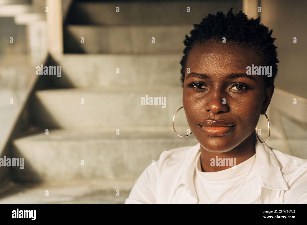 Close-up view of an African American woman looking at the camera with a serious expression on her face. Stock Photo