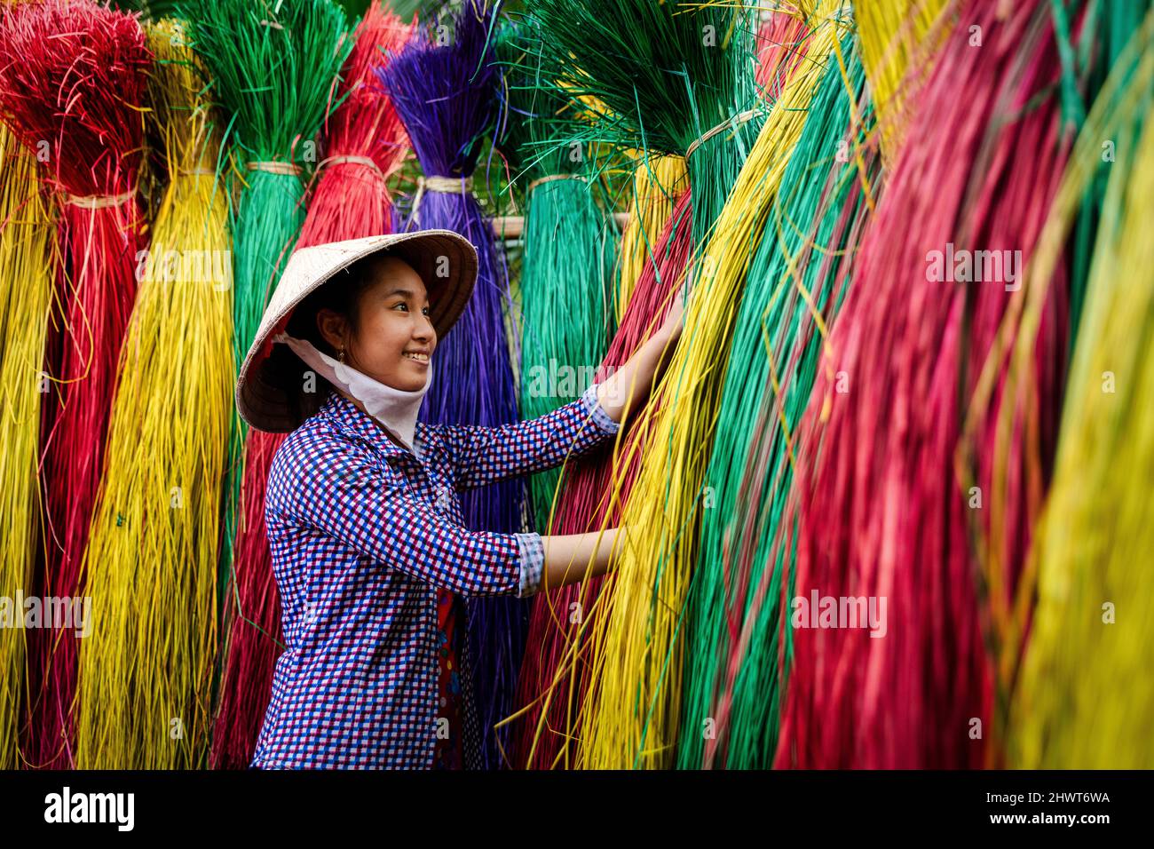 Vietnamese women drying traditional vietnam mats in the old traditional