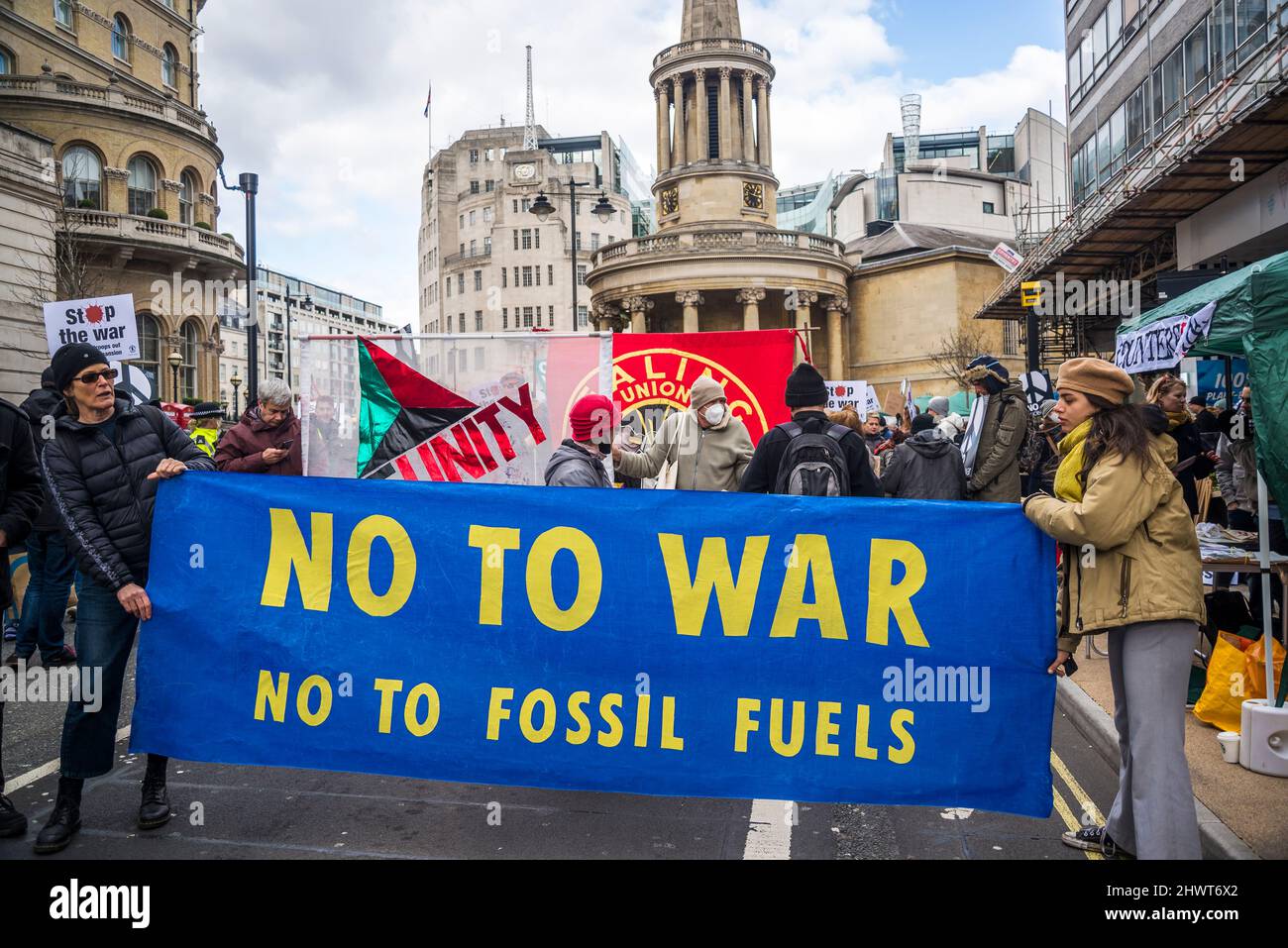 'No to war, no to fossil fuels' banner, Stop the War demonstration organised by Stop the War Coalition, London, UK, 6th March 2022 Stock Photo