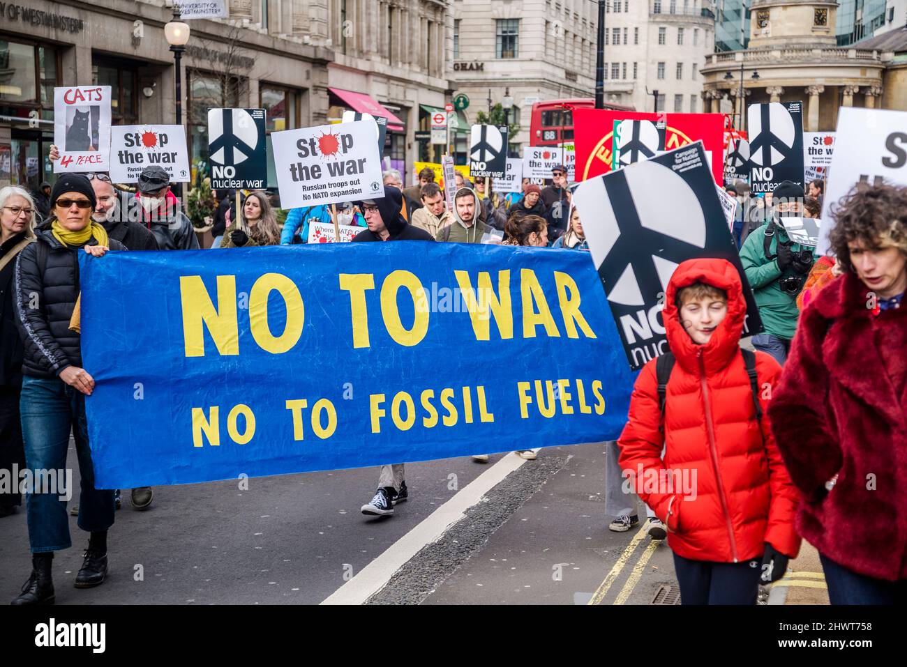'No to war, no to fossil fuels' banner, Stop the War demonstration organised by Stop the War Coalition, London, UK, 6th March 2022 Stock Photo