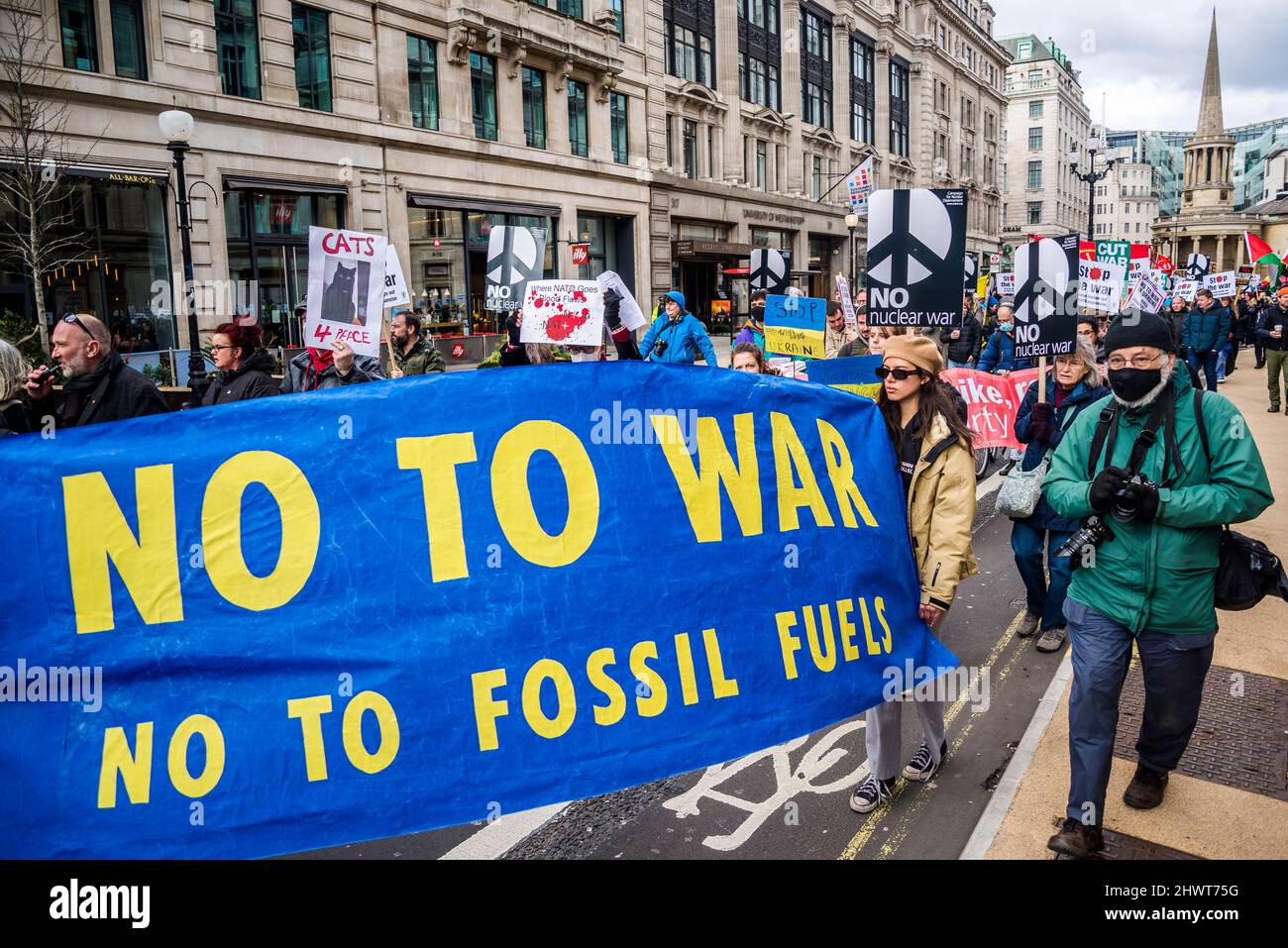 'No to war, no to fossil fuels' banner, Stop the War demonstration organised by Stop the War Coalition, London, UK, 6th March 2022 Stock Photo