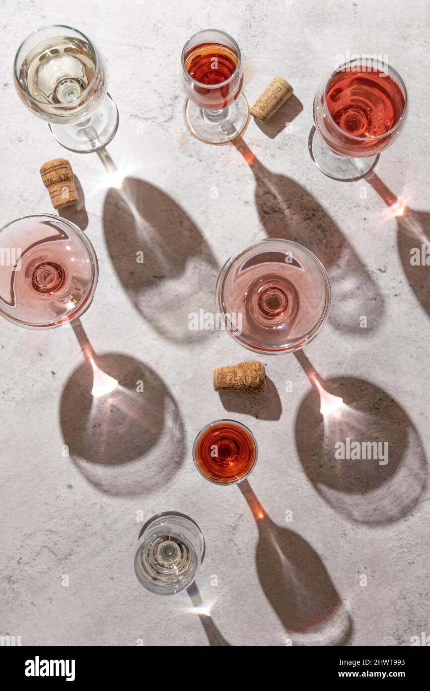 Wine glasses on grey background. Direct sunlight, aesthetic still life  Stock Photo - Alamy