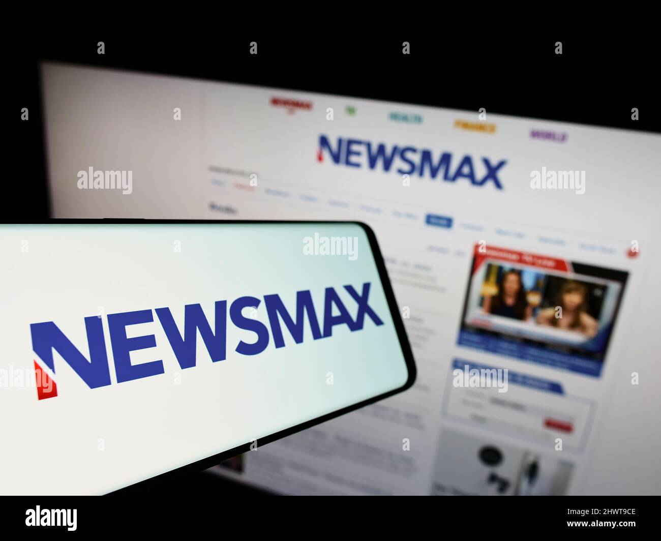 Mobile phone with logo of American media company Newsmax Media Inc. on