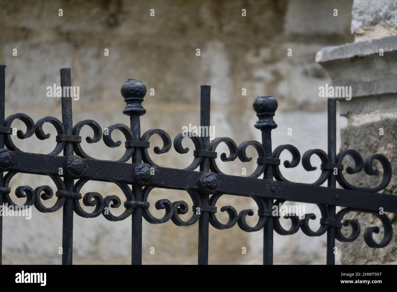 Ancient Railing Traditional handcrafted wrought iron fence railing against an ancient ...