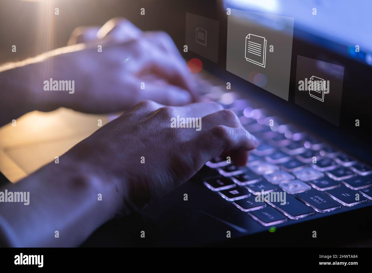 Person works with documents, data files on a laptop. Stock Photo