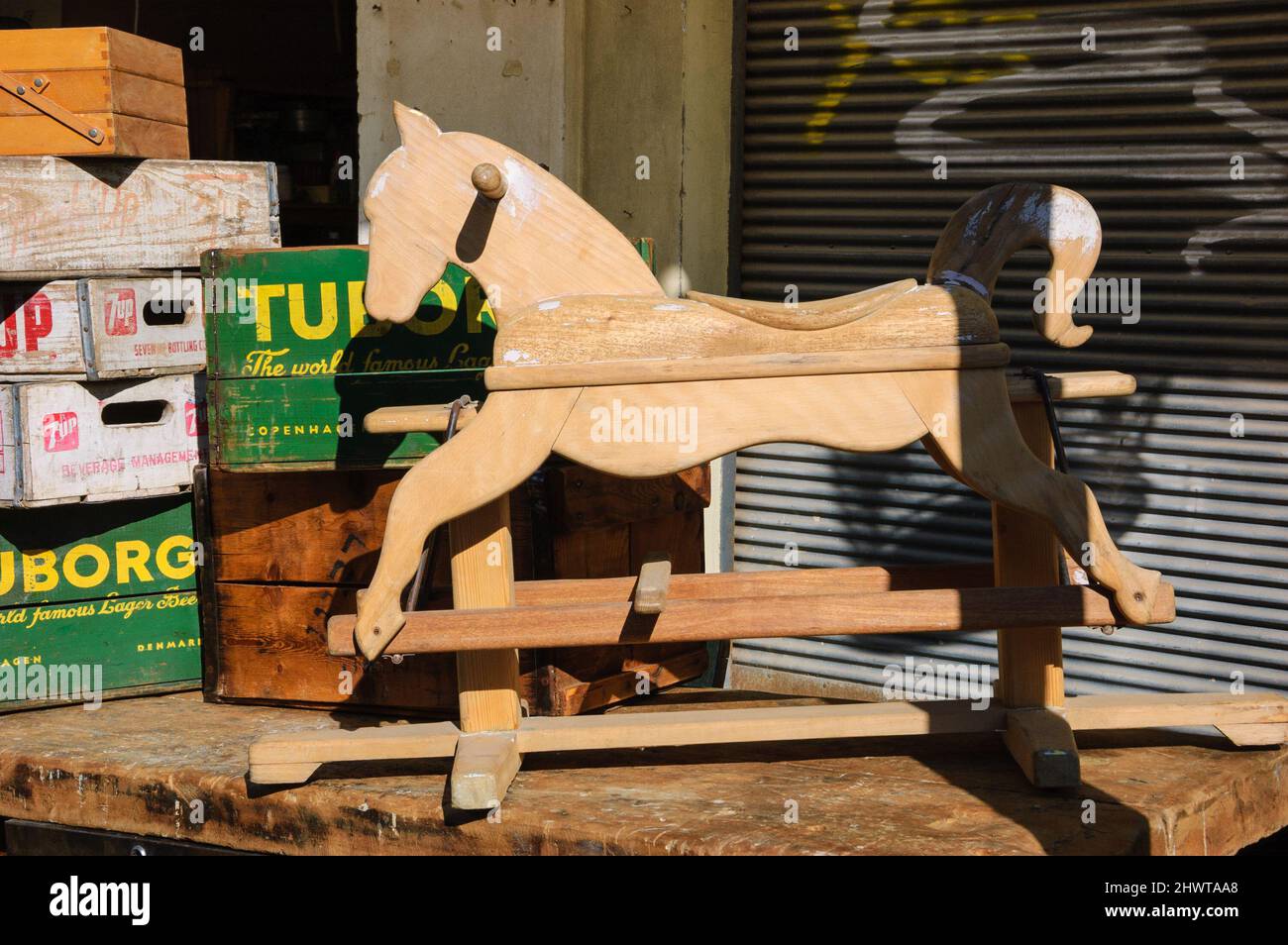 TEL AVIV-YAFO, ISRAEL - FEBRUARY 18, 2014: Wooden rocking horse and old Tuborg beer and 7up boxes for sale at Jaffa flea market Stock Photo