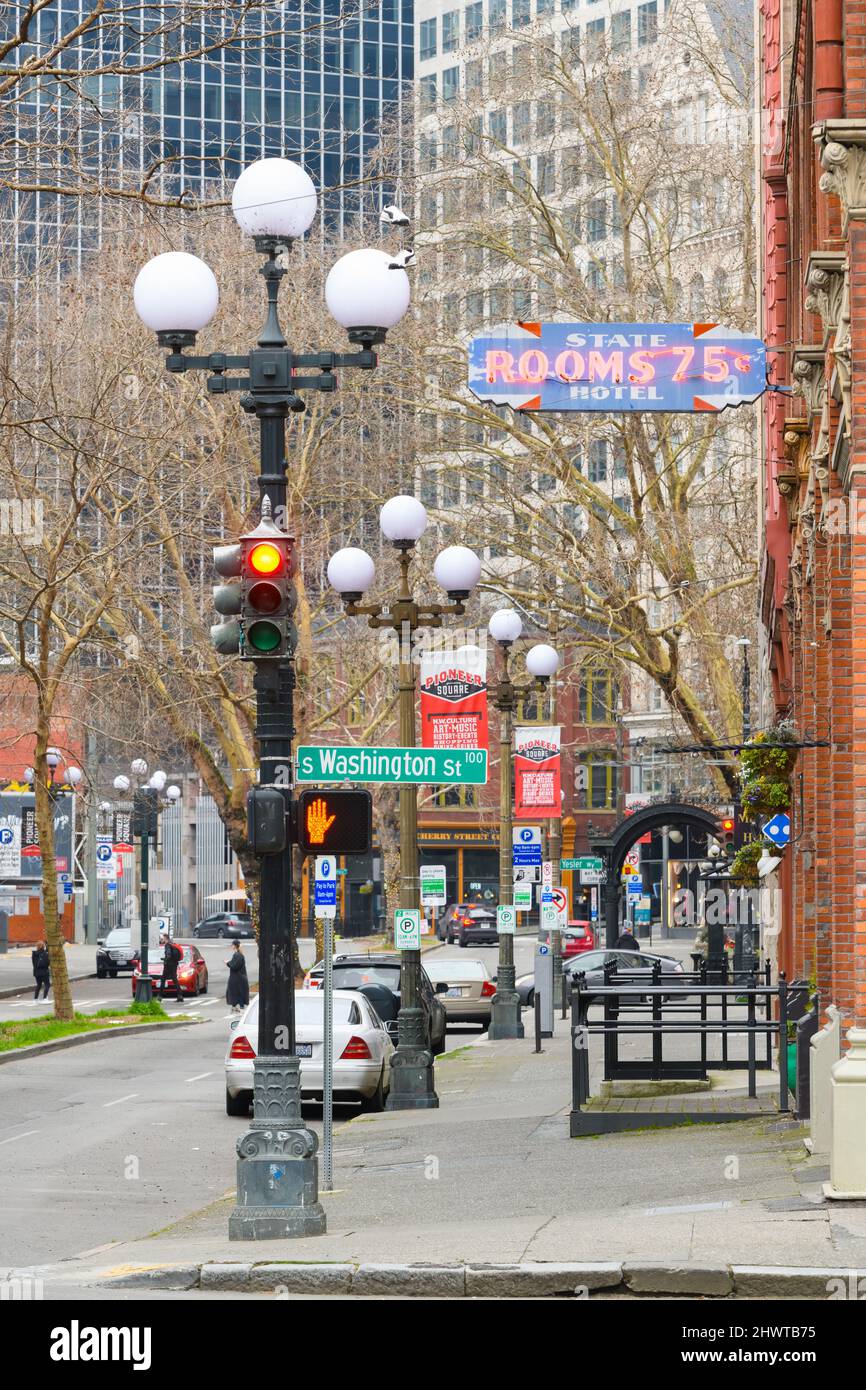 Seattle, WA, USA - March 06, 2022; 1st Avenue South in the Pioneer Square neighborhood of Seattle historic street light fixtures and neon sign Stock Photo