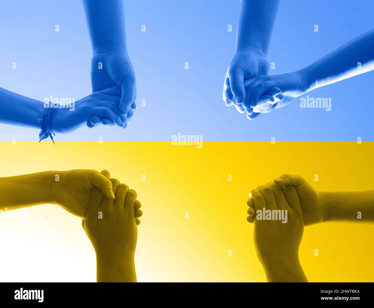 Ukrain Flag and Group of People Praying in a Circle Holding Hands Stock Photo