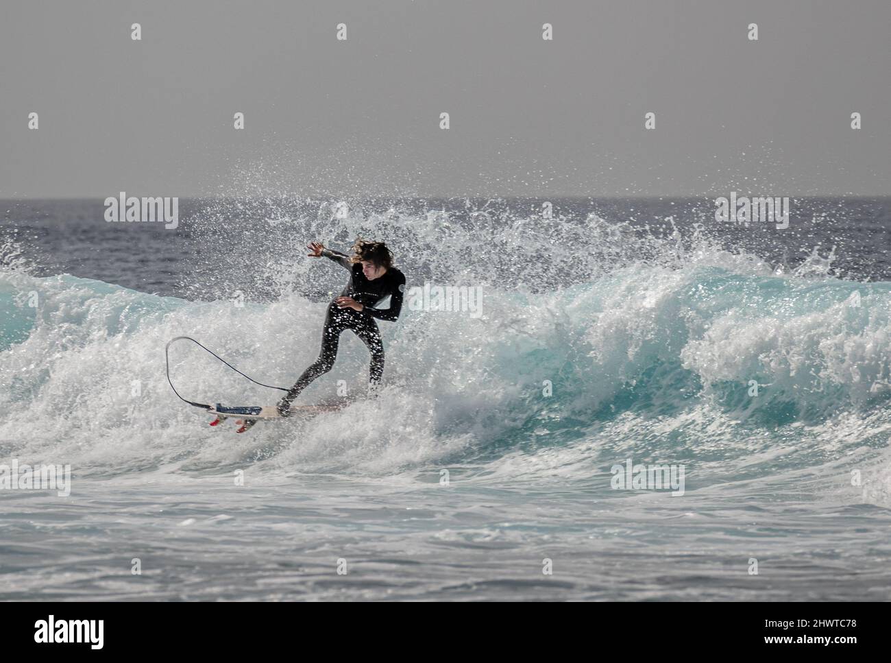 Surfers catching the waves near Playa de las Americas, Tenerife Stock Photo