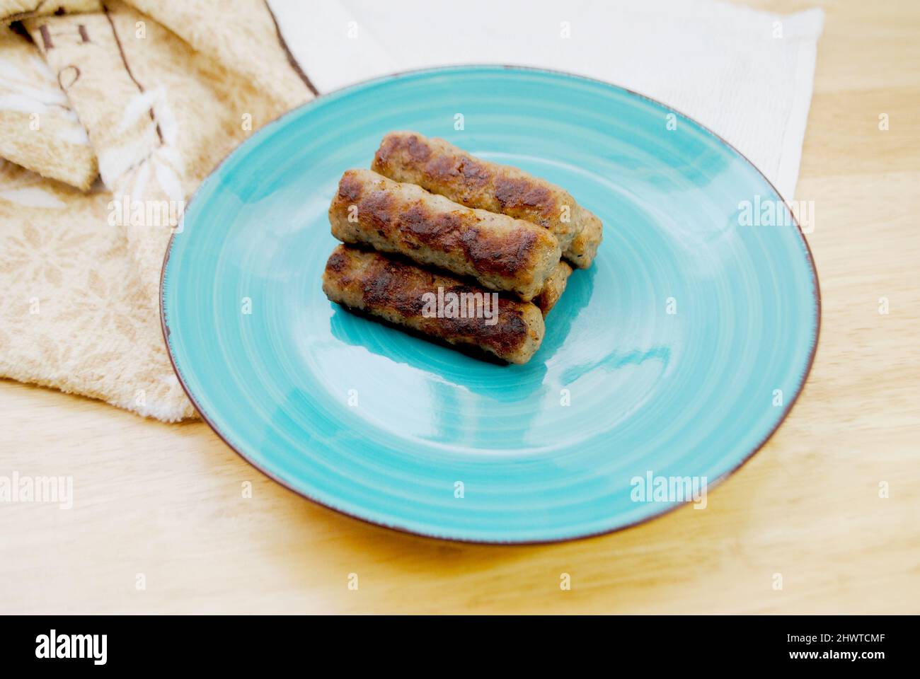 Cooked Breakfast Sausage Links Served on a Plate Stock Photo