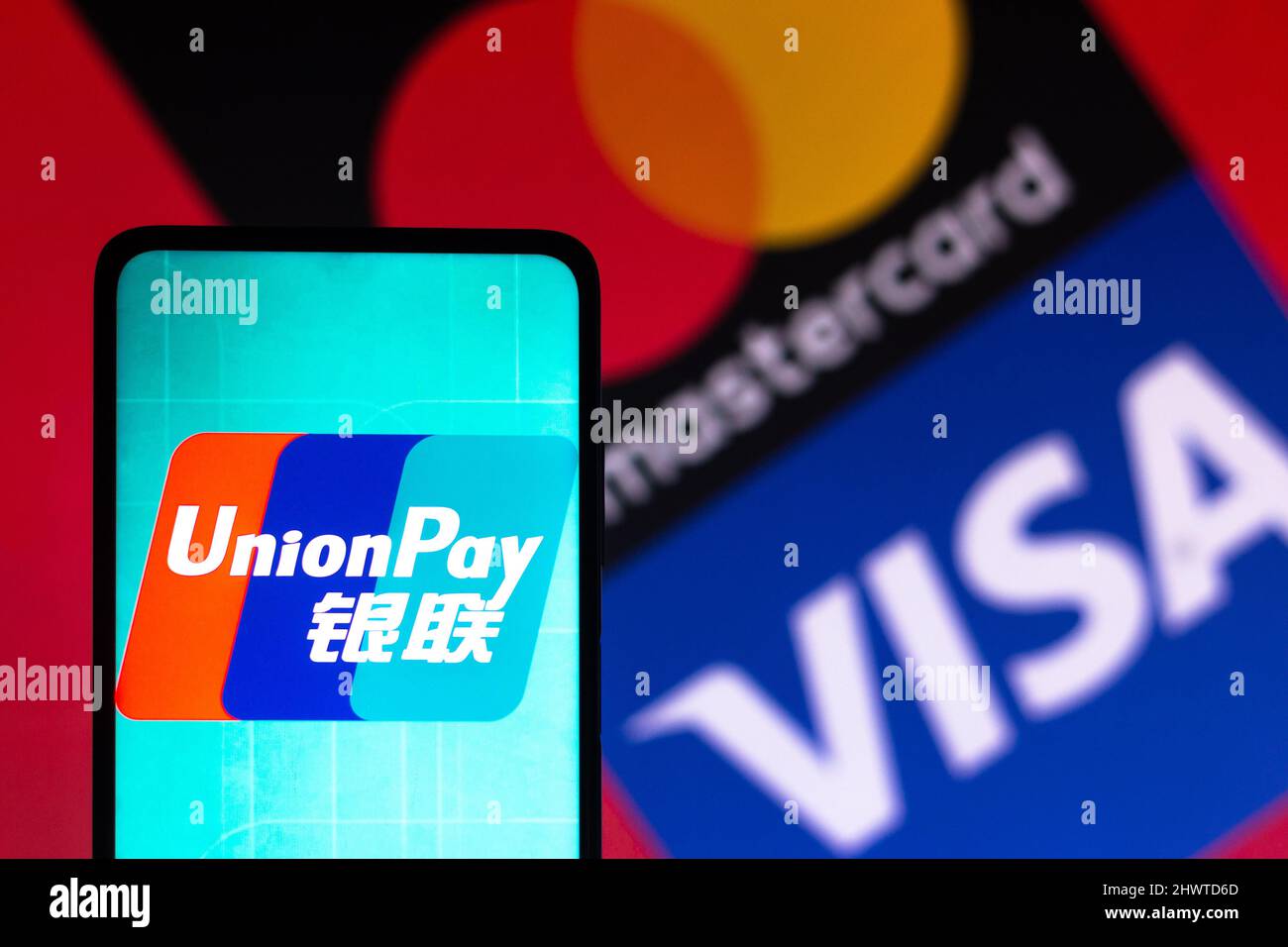 In this photo illustration, the UnionPay (CUP) logo seen displayed on a  smartphone screen with the Visa and Mastercard logos in the background  Stock Photo - Alamy