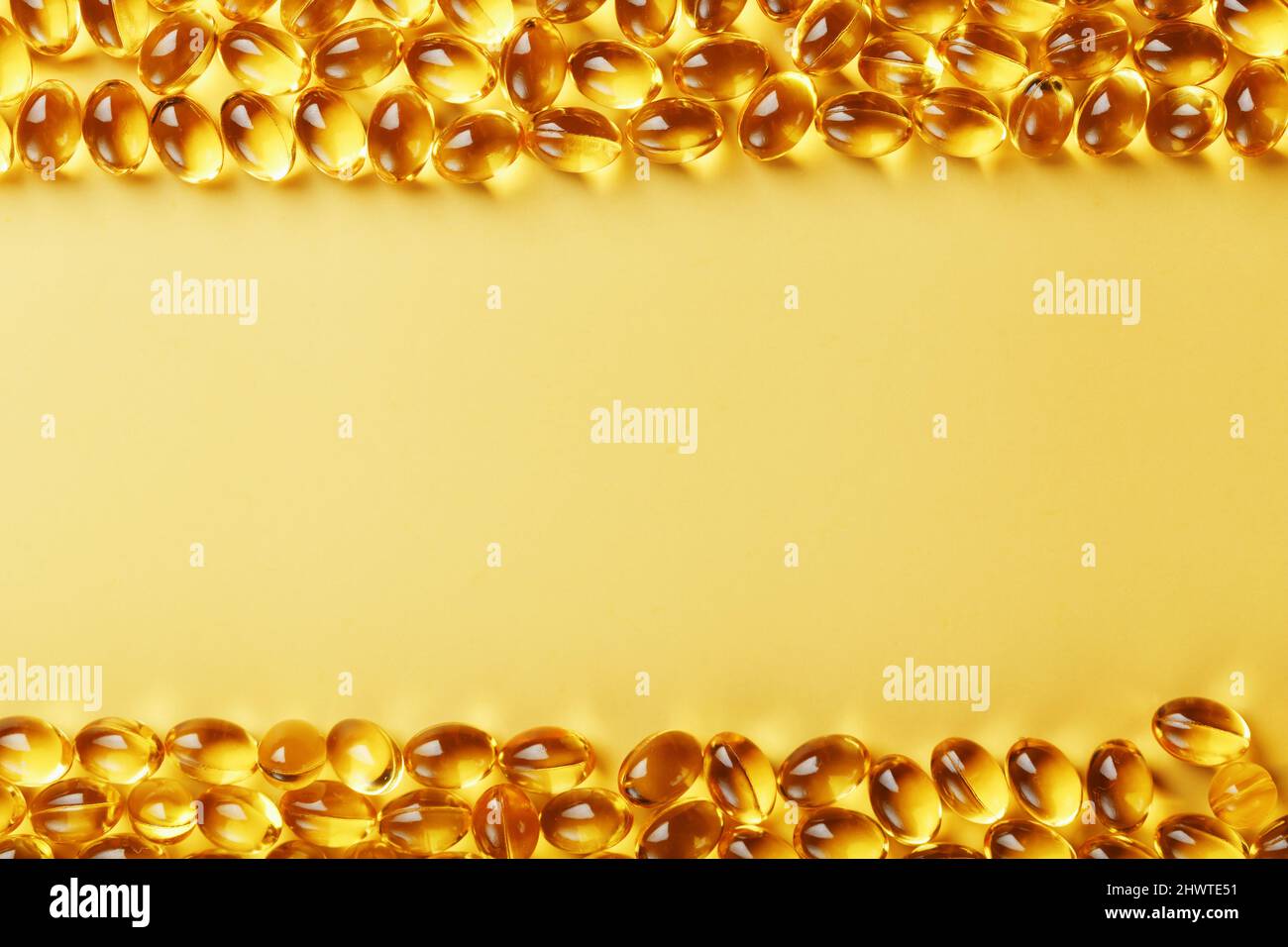 The texture of the capsules in the shell with liquid vitamin D3 in full  screen. Gold capsules with a dietary supplement for joints teeth and bones  Stock Photo - Alamy