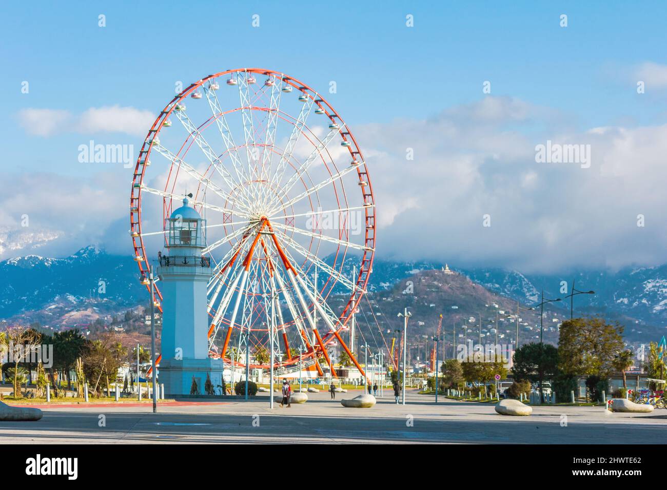 Batumi, Georgia, February 11, 2022: Ferris wheel and lighthouse Stock Photo