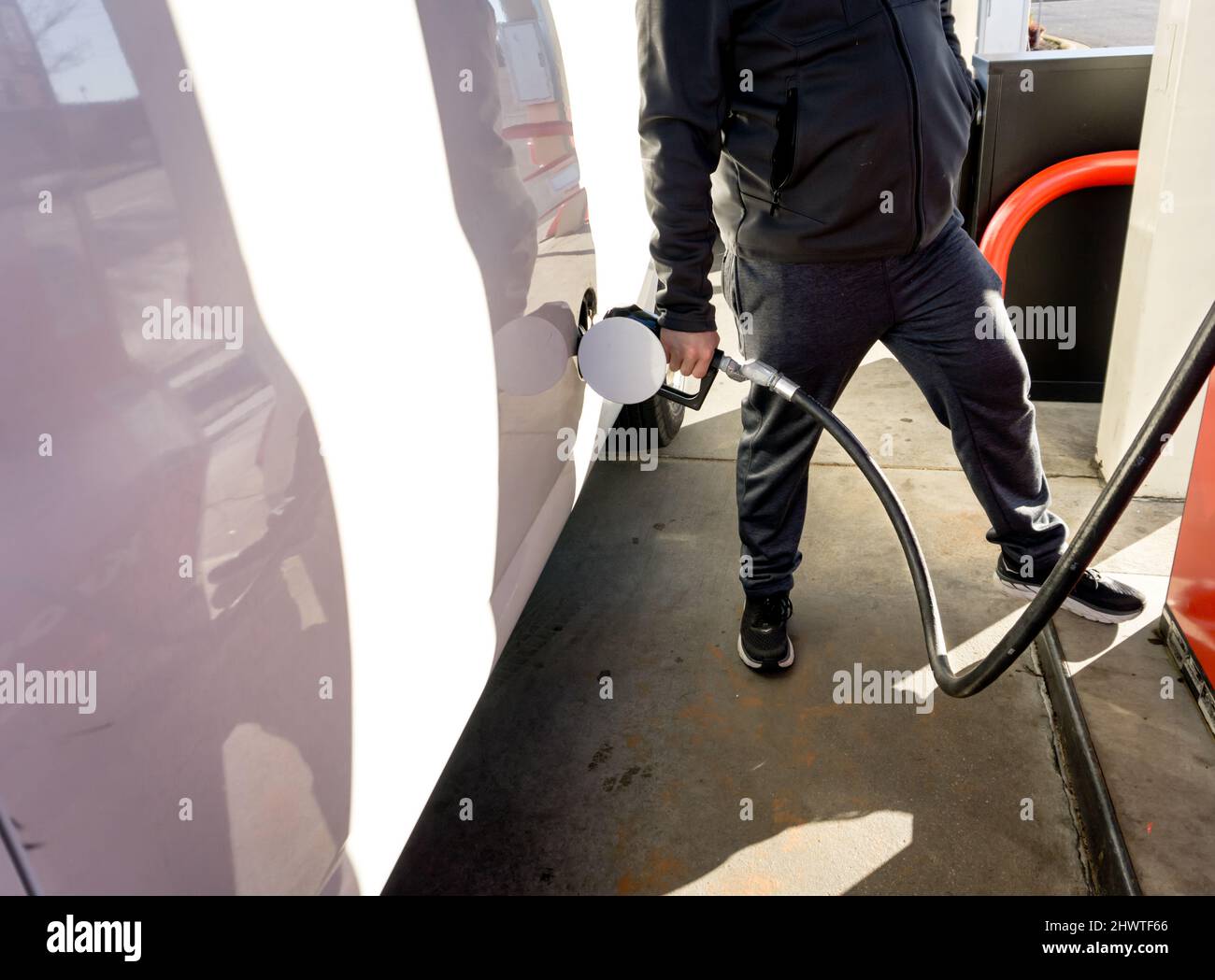 A man fills his van up with expensive gas. Stock Photo