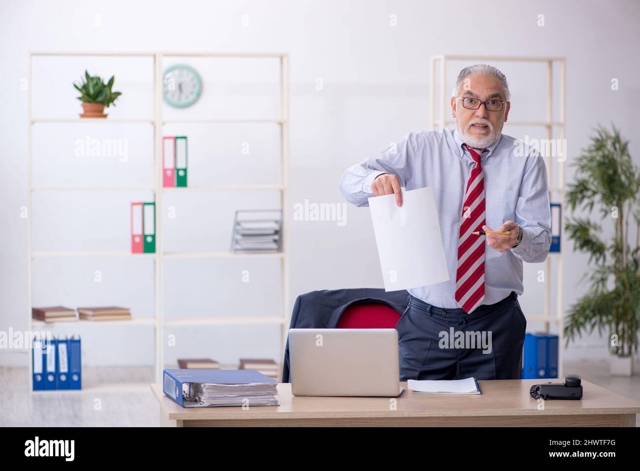 Old businessman employee working at workplace Stock Photo - Alamy