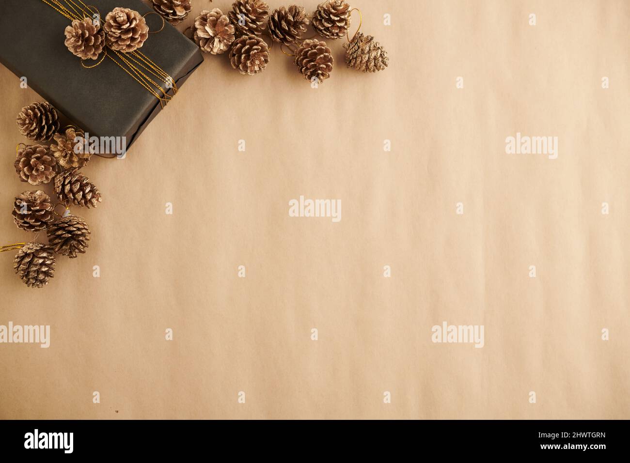 Christmas and New Year background with decorated present and pine cones