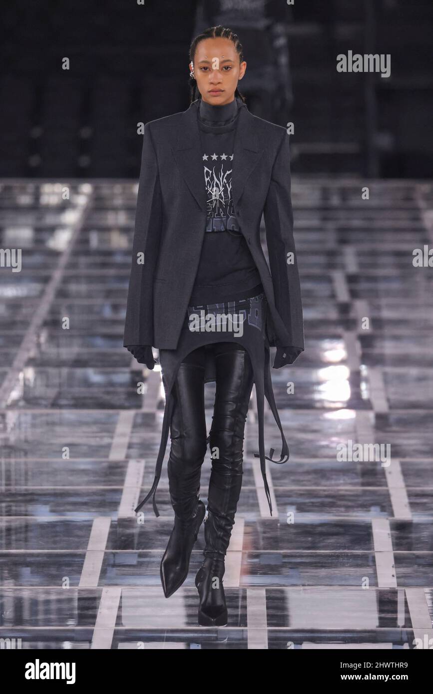 A model walks on runway of a fashion show in Paris, France and wears a Givenchy  Women and Men Ready to Wear Fall Winter 2022/2023 outfit in March 2022 at  La Defense