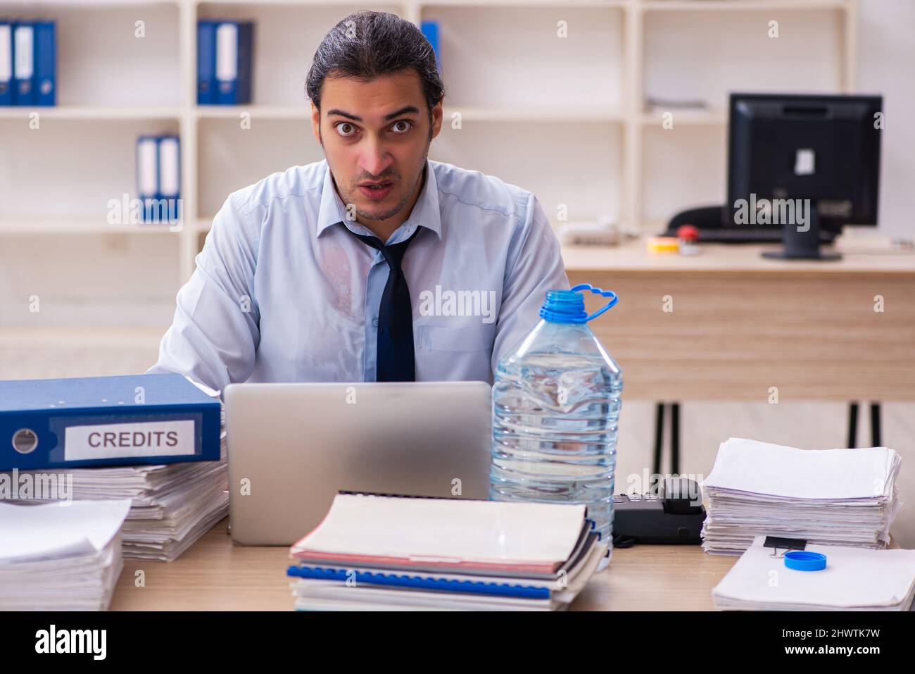 Young businessman employee sweating in the office Stock Photo - Alamy