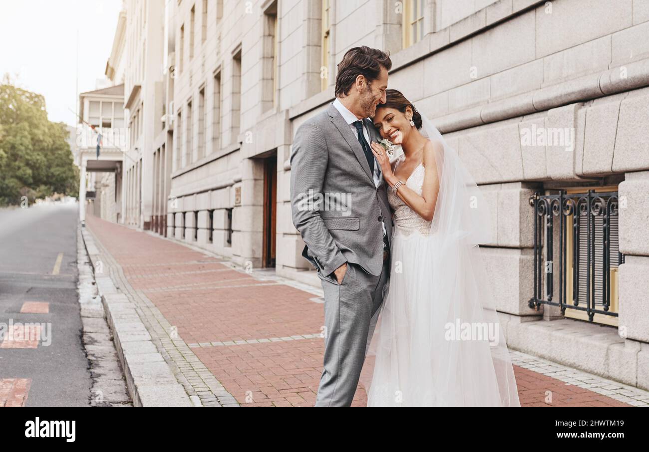 I married the one I cant go without. Shot of a beautiful couple out in the city on their wedding day. Stock Photo