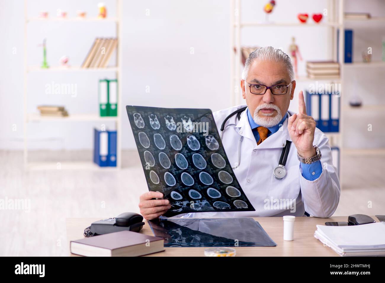 Old doctor radiologist working in the clinic Stock Photo - Alamy