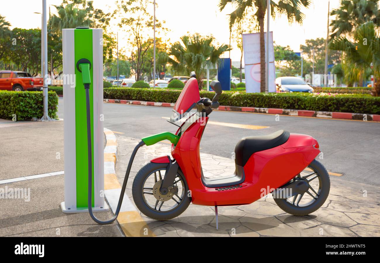 An electric scooter charging at power station Stock Photo Alamy