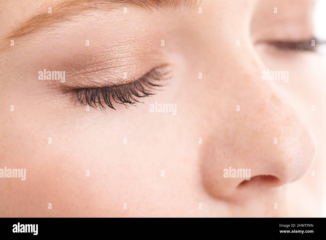 She likes to keep her make-up natural. Closeup studio shot of a model with her eyes closed. Stock Photo