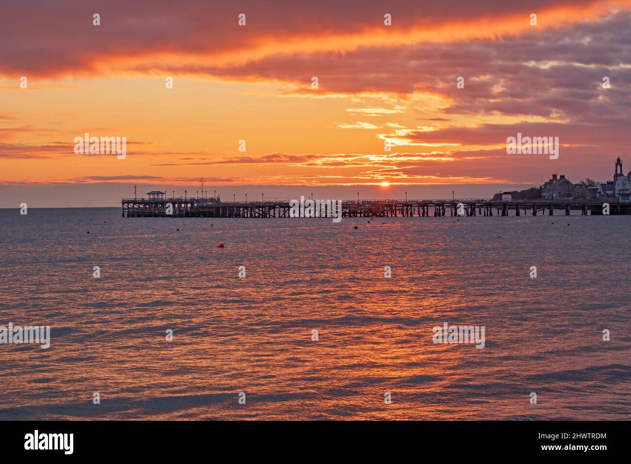 Orange sunrise over Swanage Pier Stock Photo