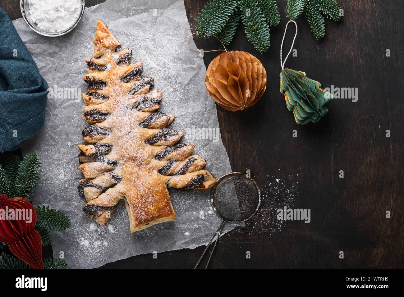 Puff pastry Christmas tree with chocolate paste, sprinkled with