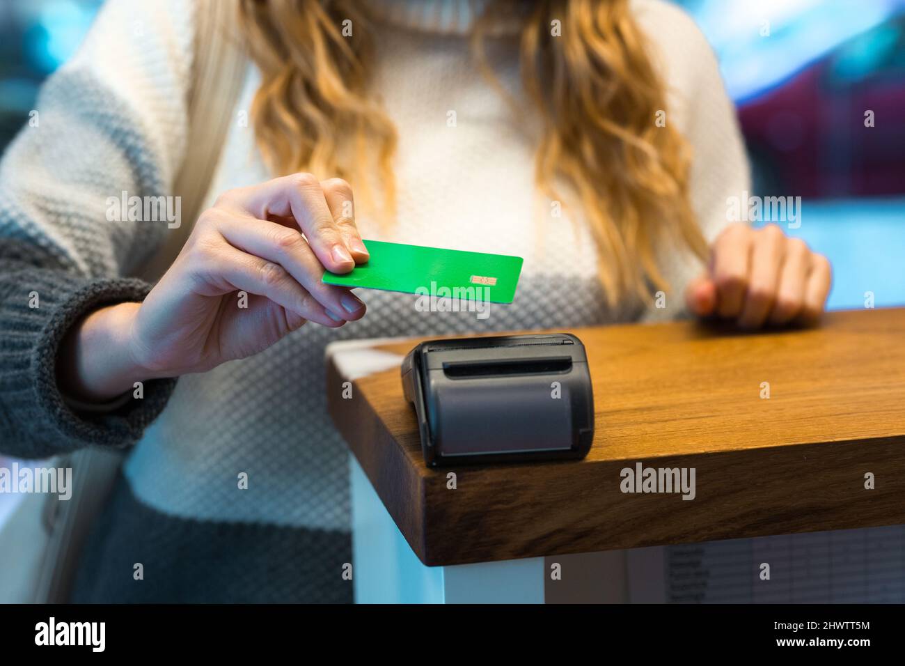 Woman paying with credit card via terminal Stock Photo