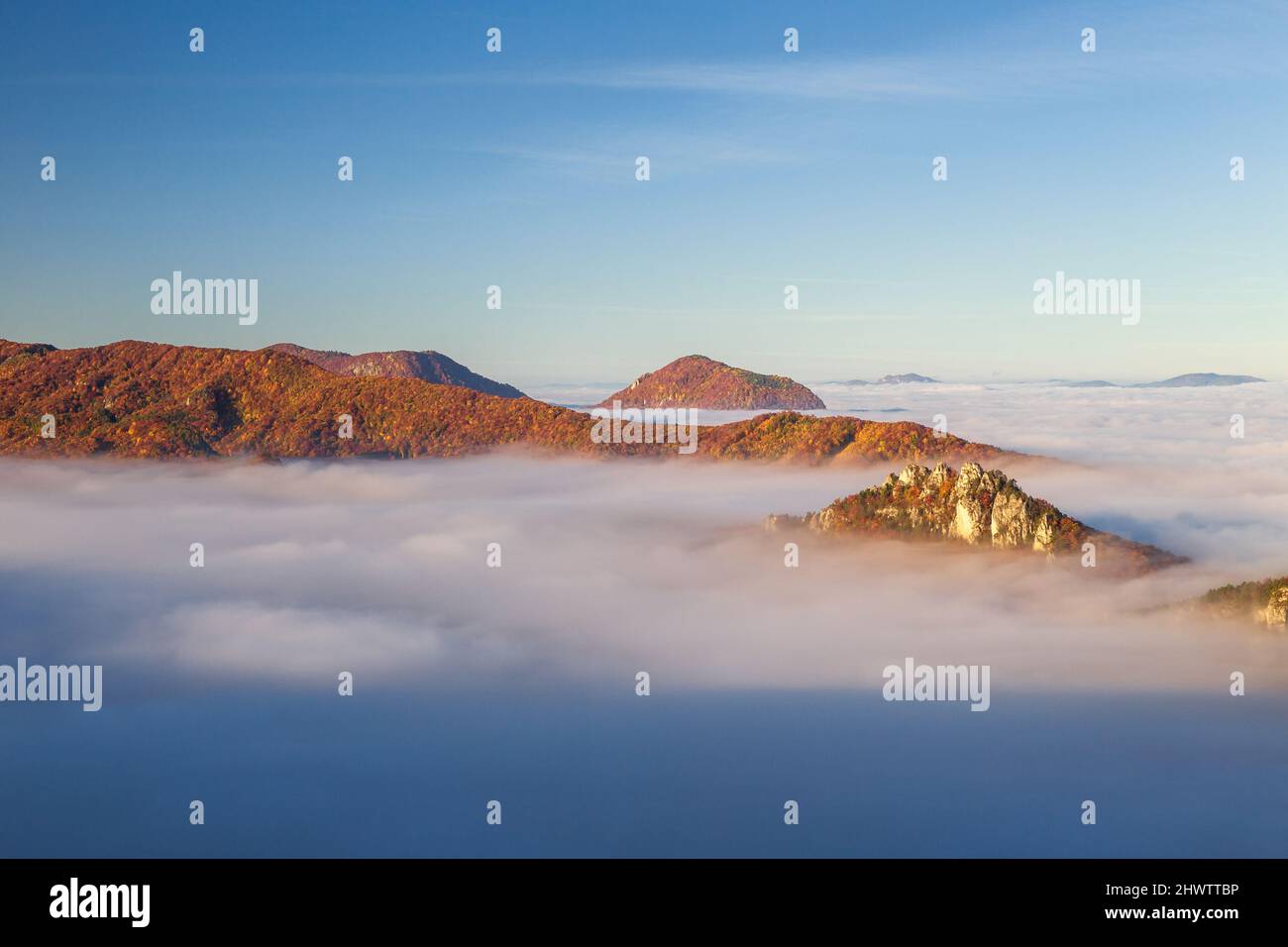 Mountain peaks over misty autumn landscape. Morning inversion in the Sulov rock mountains, Slovakia Europe. Stock Photo