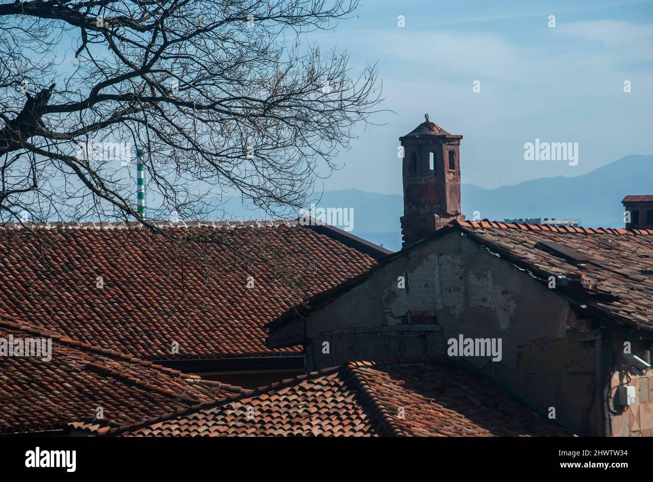 Old roofs and chimneys closeup on blue sky background Stock Photo - Alamy