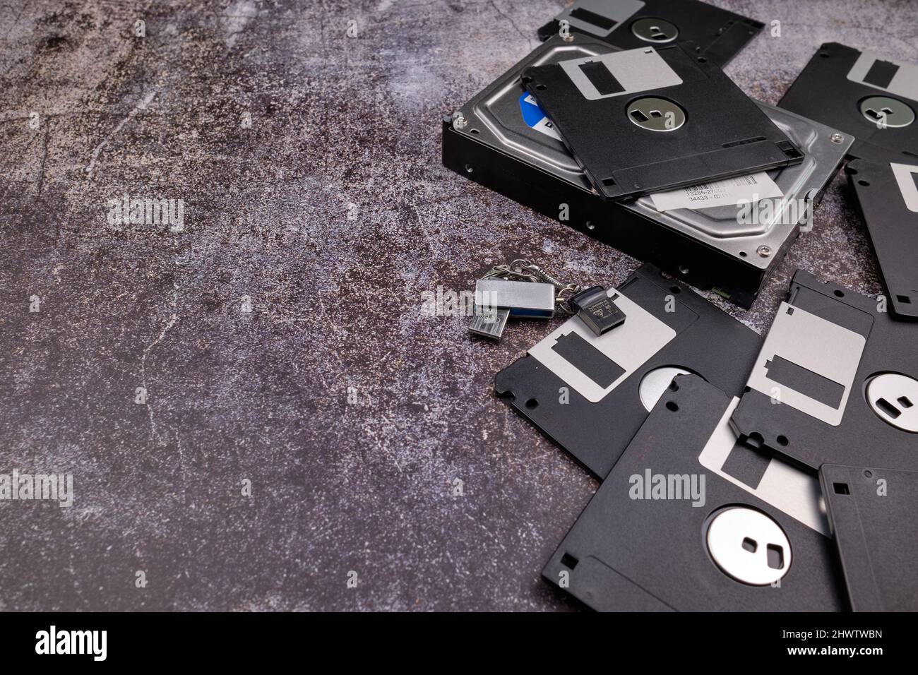 Technological background formed by different components of a computer on a table with a color similar to cement and with empty space. Stock Photo