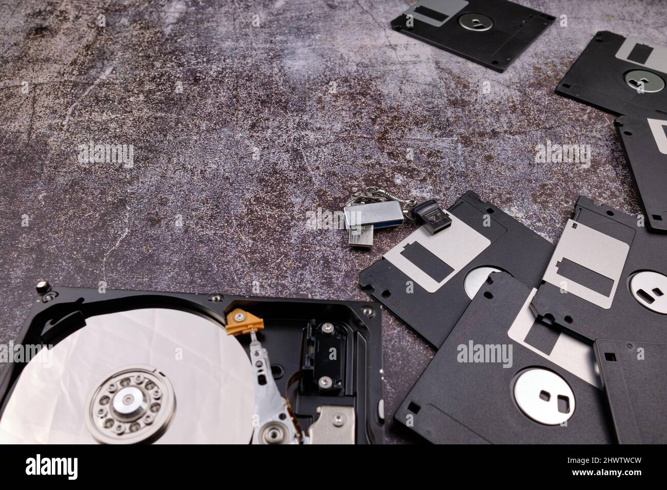 Technological background formed by different components of a computer on a table with a color similar to cement and with empty space. Stock Photo