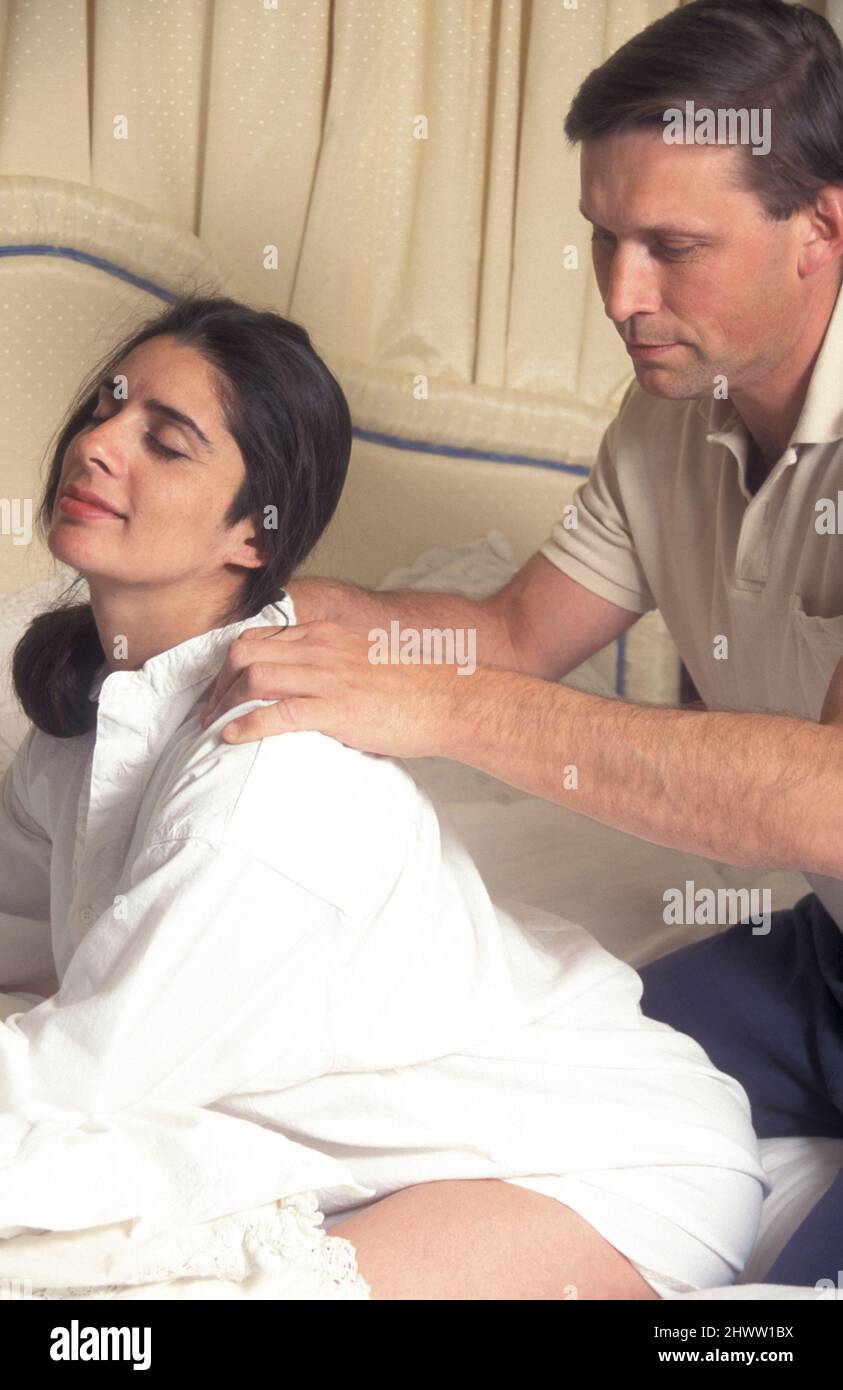 man helping pregnant partner to relax during labour Stock Photo
