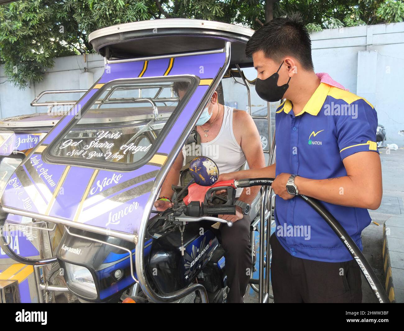 A tricycle is being refueled by a gasoline attendant. The Philippines is experiencing soaring prices in oil and other fuel products amid the Russia-Ukraine conflict. The Department of energy warns the public to brace for much more higher cost of fuel in the days ahead. they said this price fallout is not only happening to the Philippines but also in other parts of the world. The Philippine Government is preparing contingency plan to subsidize the fuel costs for public transportation sector, farmers and fisher folk. Stock Photo