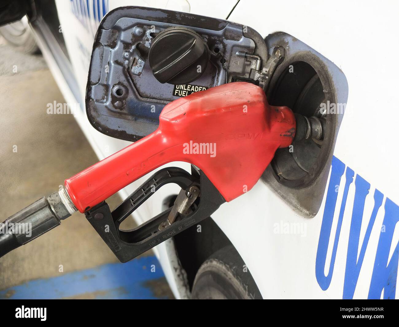 A gas pump is inserted in a taxi fuel tank. The Philippines is