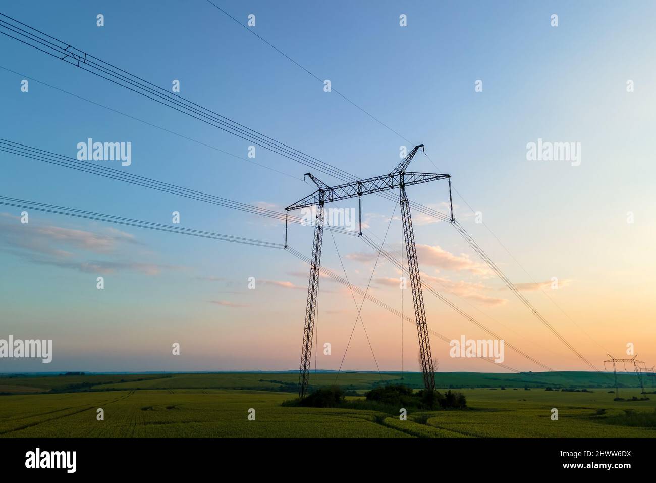 High voltage towers with electric power lines at sunset Stock Photo - Alamy