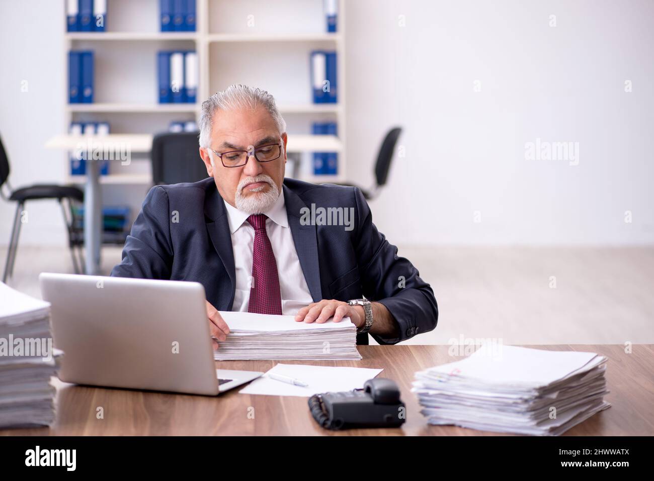 To Much Work Old employee and too much work in the office Stock Photo - Alamy