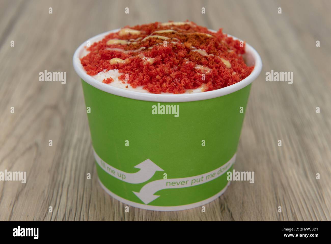 Delicious ice cream esquite topped with spicy crumbs and served in a take out order cup. Stock Photo