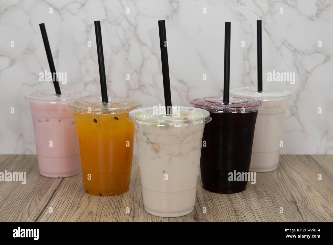 Variety of aqua frescas flavored sweet drinks in a take out order cup to dink on the go. Stock Photo