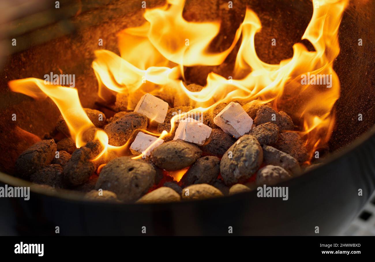 Fireside fun. Closeup of a warm fire burning in a barbeque Stock Photo ...