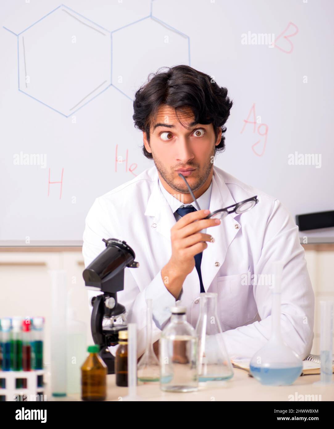 Young funny chemist in front of white board Stock Photo