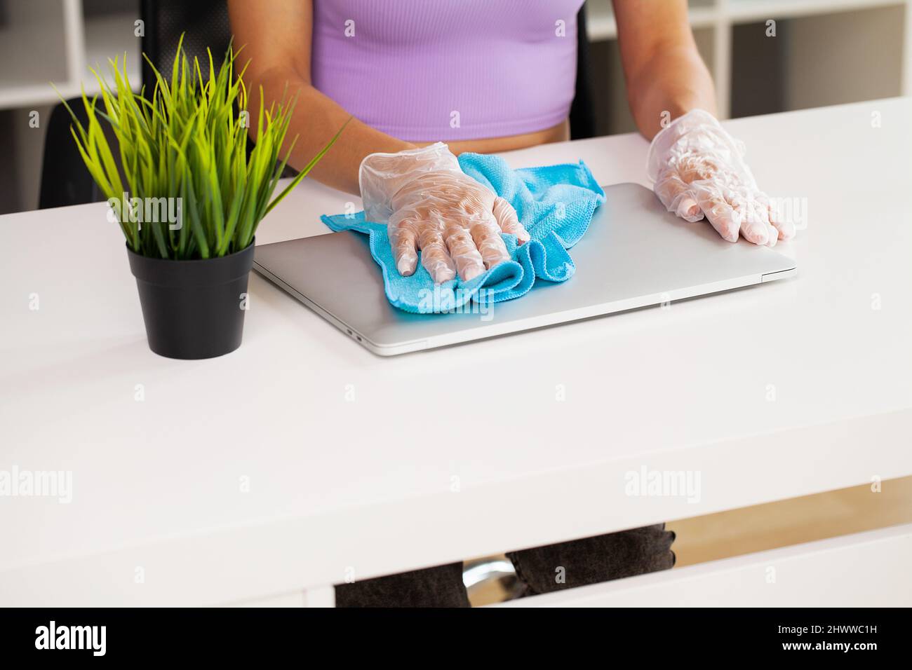 Woman wipes the laptop with a damp disinfectant wipe Stock Photo Alamy
